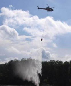 A helicopter performing water bombing.