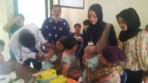 A doctor checks on a child in one of the healthcare and medical posts set up by RAPP for the Kuansing community.