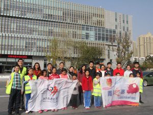 Asia Symbol staff from its Shandong-based pulp and paperboard plant walked side-by-side 14 excited and energetic children along the Rizhao river