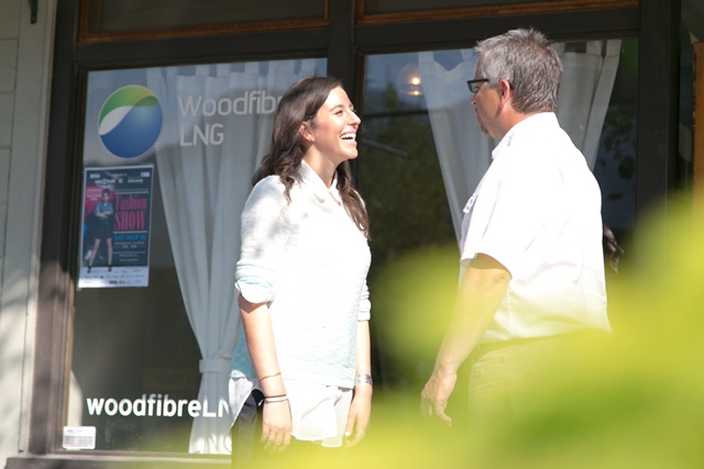 Residents chat outside the Woodfibre LNG community office in Squamish