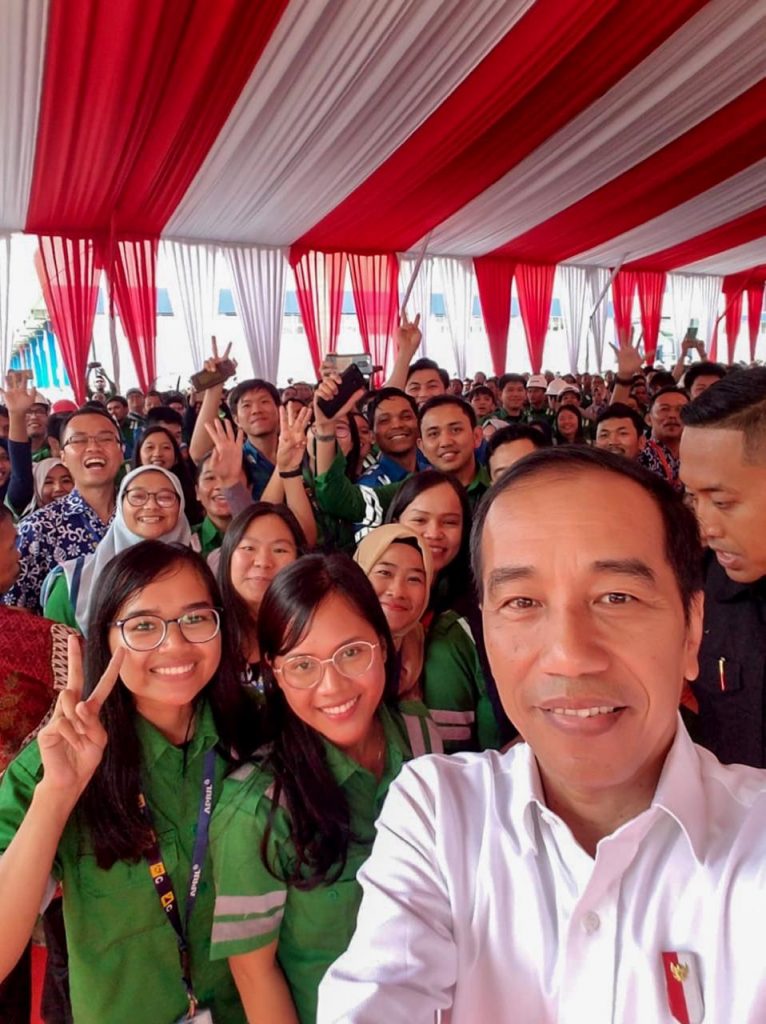 President Joko Widodo takes wefie to capture a historical moment with employees of Asia Pacific Rayon and APRIL Group